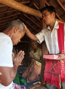 Pastor praying over a man