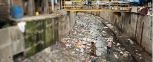 people in the slum looking at rubbish