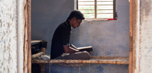 Man reading Bible on bed