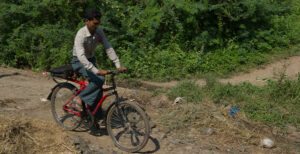 A pastor travels on his bicycle