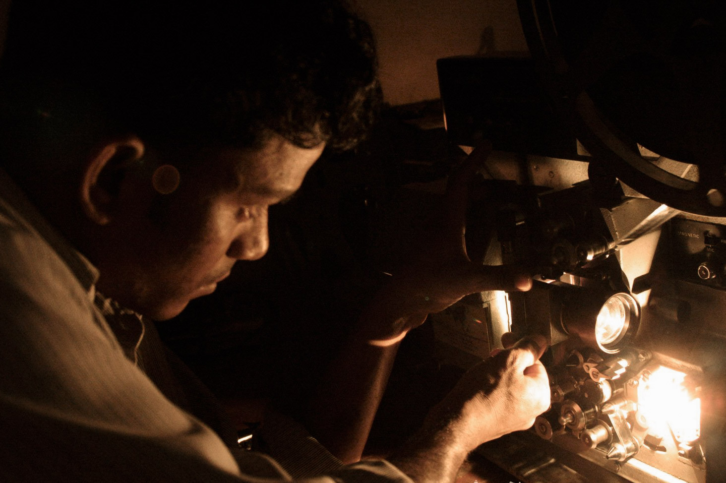 Man fixing movie projector