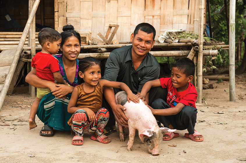 Pray for People to Recieve Animals: Family with a gifted pig