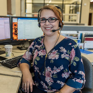 woman sitting at a computer desk in an office