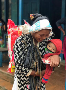 Compassion - Joyful woman receiving a bag of rice 